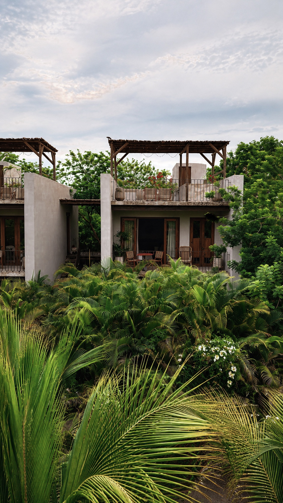 Private hotel suite framed by tropical gardens