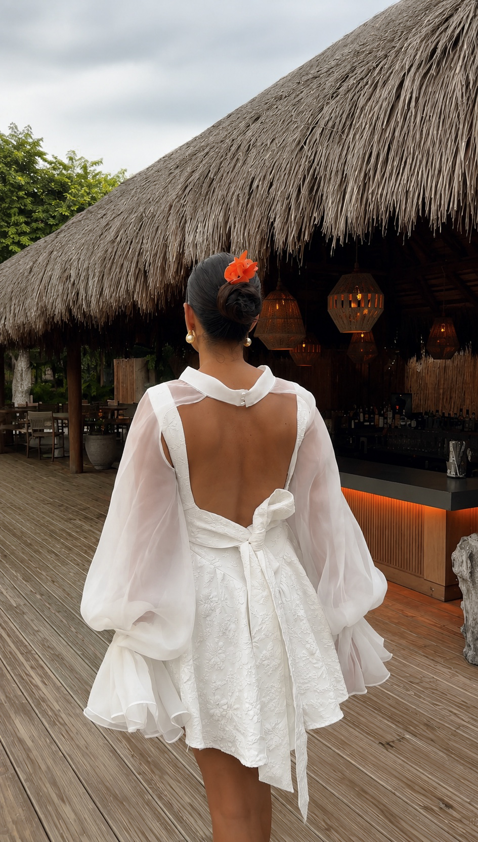 Guest approaching a warmly lit tropical bar