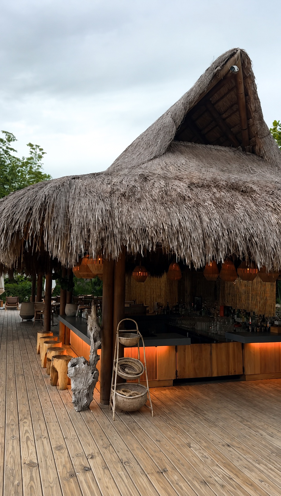Open-air bar beneath a thatched roof