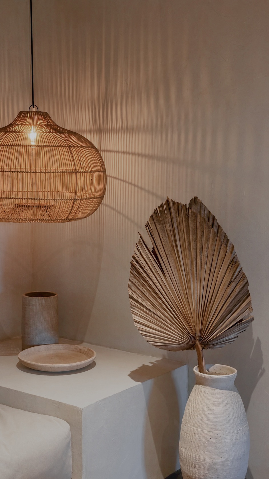 Woven lamp and sculptural palm-leaf design detail
