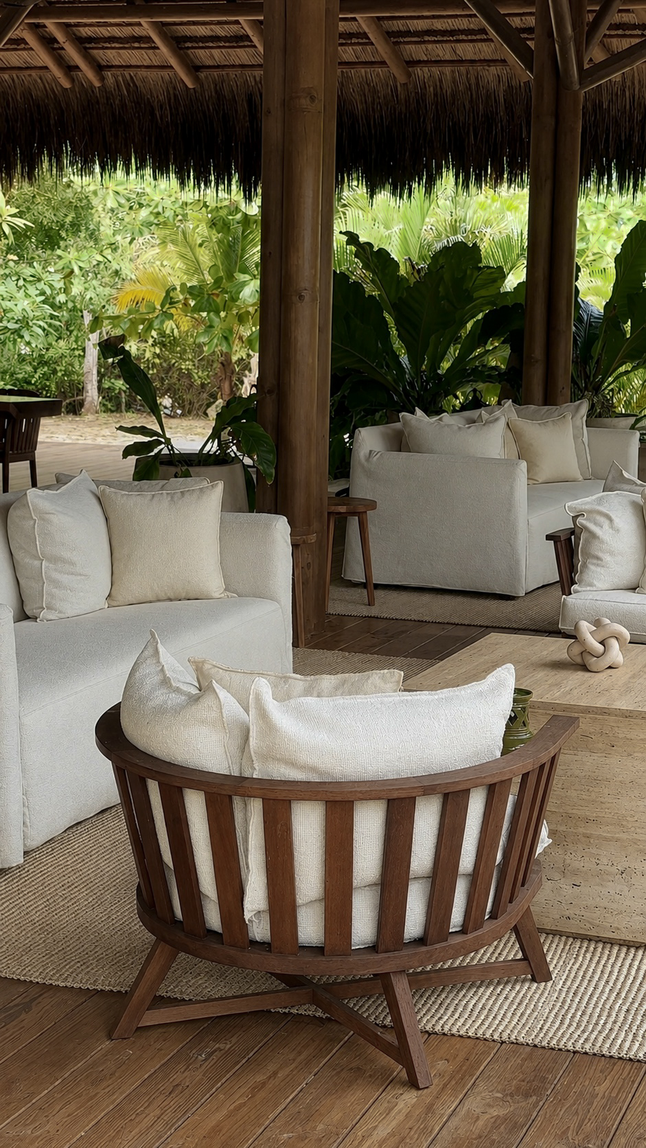 Neutral open-air lounge with wood-framed seating